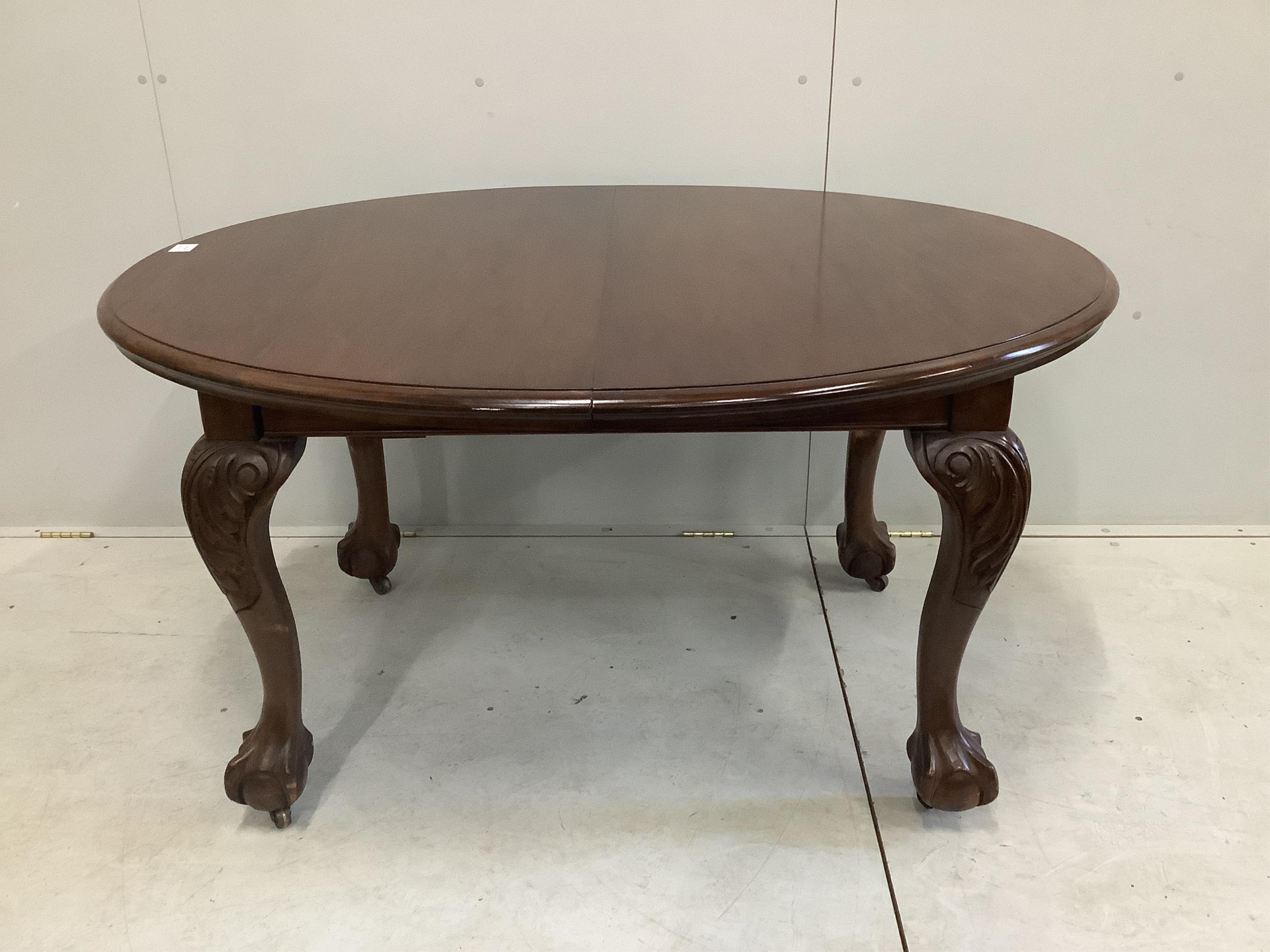 A 1930's walnut extending dining table, 182cm extended, height 106cm and a set of six Queen Anne Revival dining chairs. Condition - fair to good